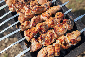 The meat is fried on sticks on charcoal