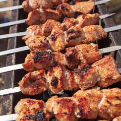 The meat is fried on sticks on charcoal