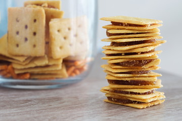 Biscuit with pineapple jam on the wooden table.