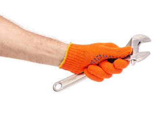 Adjustable wrench in hand construction gloves on white background isolation