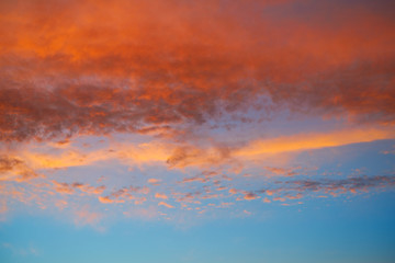 Sunset sky with orange clouds and blue