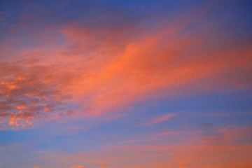 Naklejka na ściany i meble Sunset sky with orange clouds and blue