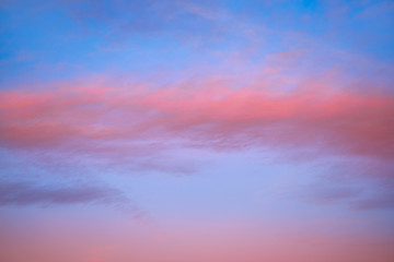 Naklejka na ściany i meble Sunset sky with orange clouds and blue skies