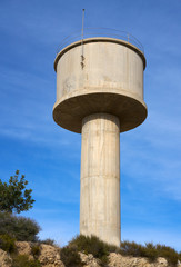 concrete water tower with blue sky