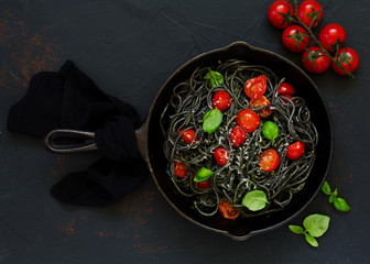 Spaghetti with cuttlefish ink and tomatoes.