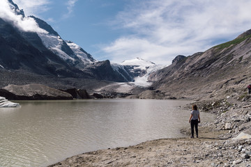 Rear view of woman on lake by glacier