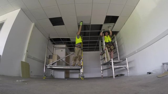 Construction, installing ceiling tiles to the grid in small area