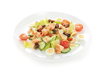 warm salad sea breeze with tomato cherry squid mussels roasted salmon quail eggs on a white background
