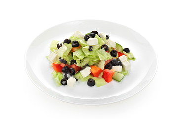 Greek salad with cheese and fresh vegetables on a white background isolated