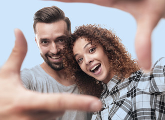 newlyweds look in the frame of the fingers.