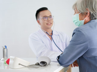 Elderly woman in hospital with doctor.