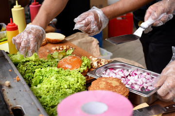 street food, process of cooking beef burgers outdoors on open kitchen