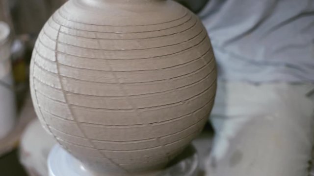 Closeup potter rotate jar with crack texture on potter's wheel