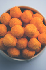 Kaju Katli is a Diamond shape Indian sweet made using cashew sugar and mava, served in a plate or bowl over moody background. selective focus