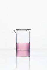 Laboratory Glassware. Glass With Pink Liquid On White Background