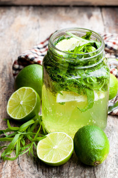 Green  lemonade with tarragon and lime on wooden background