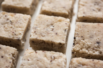 Raw and cooked Barley pearl seeds in a bowl or over white plate. selective focus