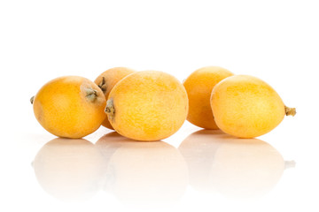 Fresh orange Japanese loquats stack isolated on white background.