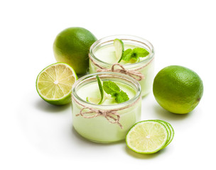 Natural  lime yogurt in a small glass jar isolated on white