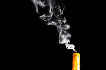Yellow Candle with white smoke on black background