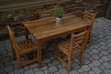 Little wooden table with chairs for children to eat and play at the restaurant