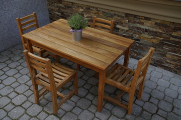 Little wooden table with chairs for children to eat and play at the restaurant