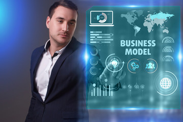 Business, Technology, Internet and network concept. Young businessman working on a virtual screen of the future and sees the inscription: Business model