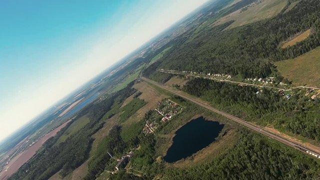 Aerial view from Airplane. Long flight along green landscape. Russia landscape. Footage for air battle or high speed chase. Great for documental films about nature.