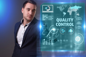 Business, Technology, Internet and network concept. Young businessman working on a virtual screen of the future and sees the inscription: Quality control