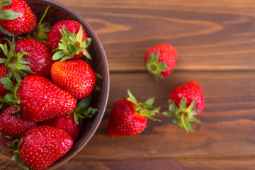 Red strawberries on a table in a plate, summer berry.