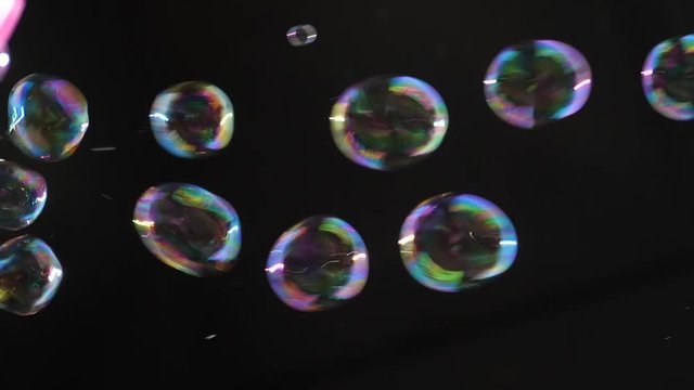 Flying soap bubbles on a dark background