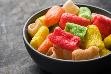 Diwali sweets arranged in a plate with diya and flowers
