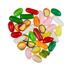 Sweets, sweet bright colored caramel, in the shape of heart, on a white background