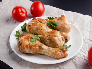 Grilled, roast chicken legs and vegetables clouse-up.