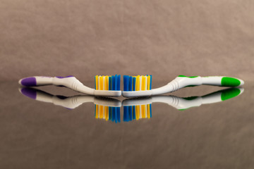 Brushes for cleaning teeth with purple and green pens on a background of crumpled paper with...