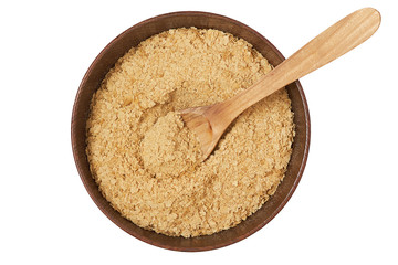 Nutritional brewers yeast flakes in wooden bowl isolated on white background. Top view