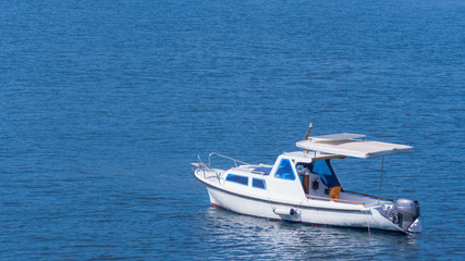 Fototapeta premium white boat in the blue sea