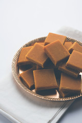 Alphonso Mango Burfi or Hapus Amba Vadi served in a plate, selective focus