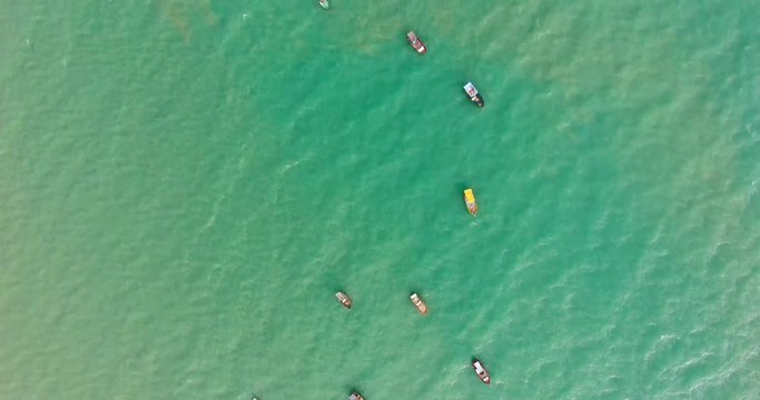 Aerial view of traditional fishing boat moored in the turquoise sea of Rio do Fogo, Brazil.