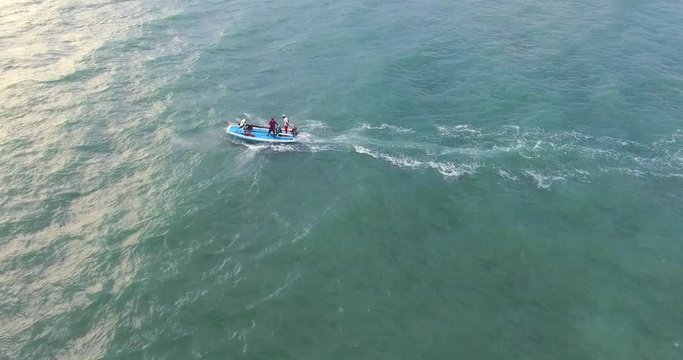 RIO DO FOGO, BRAZIL - JANUARY 5, 2018: Aerial view of traditional fishing boat driving in the turquoise sea of Rio do Fogo, Brazil.
