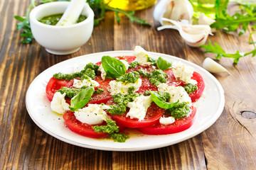 Delicious salad of tomato, mozzarella and pesto.