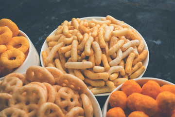 Kaju Katli is a Diamond shape Indian sweet made using cashew sugar and mava, served in a plate or bowl over moody background. selective focus
