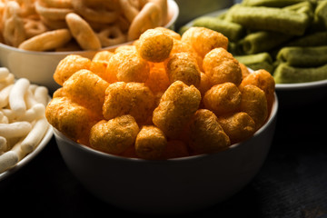 Kaju Katli is a Diamond shape Indian sweet made using cashew sugar and mava, served in a plate or bowl over moody background. selective focus