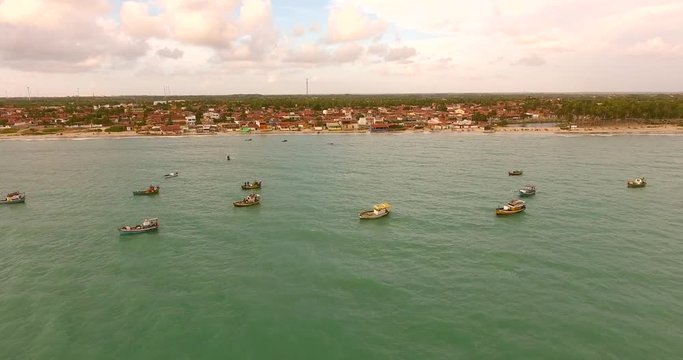 Aerial view of traditional fishing boat moored in the turquoise sea of Rio do Fogo, Brazil.