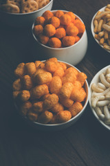 Kaju Katli is a Diamond shape Indian sweet made using cashew sugar and mava, served in a plate or bowl over moody background. selective focus