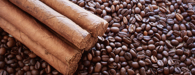 Background from coffee grains with the Cuban cigars