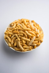 Tilgul Laddu or Til Gul balls for makar sankranti, it's a healthy food made using sesame, crushed peanuts and jaggery. served in a bowl. selective focus showing details.