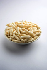 Kaju Katli is a Diamond shape Indian sweet made using cashew sugar and mava, served in a plate or bowl over moody background. selective focus