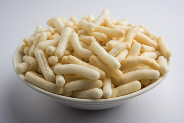 Kaju Katli is a Diamond shape Indian sweet made using cashew sugar and mava, served in a plate or bowl over moody background. selective focus