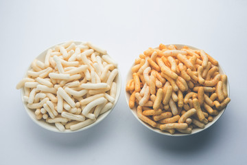 Kaju Katli is a Diamond shape Indian sweet made using cashew sugar and mava, served in a plate or bowl over moody background. selective focus